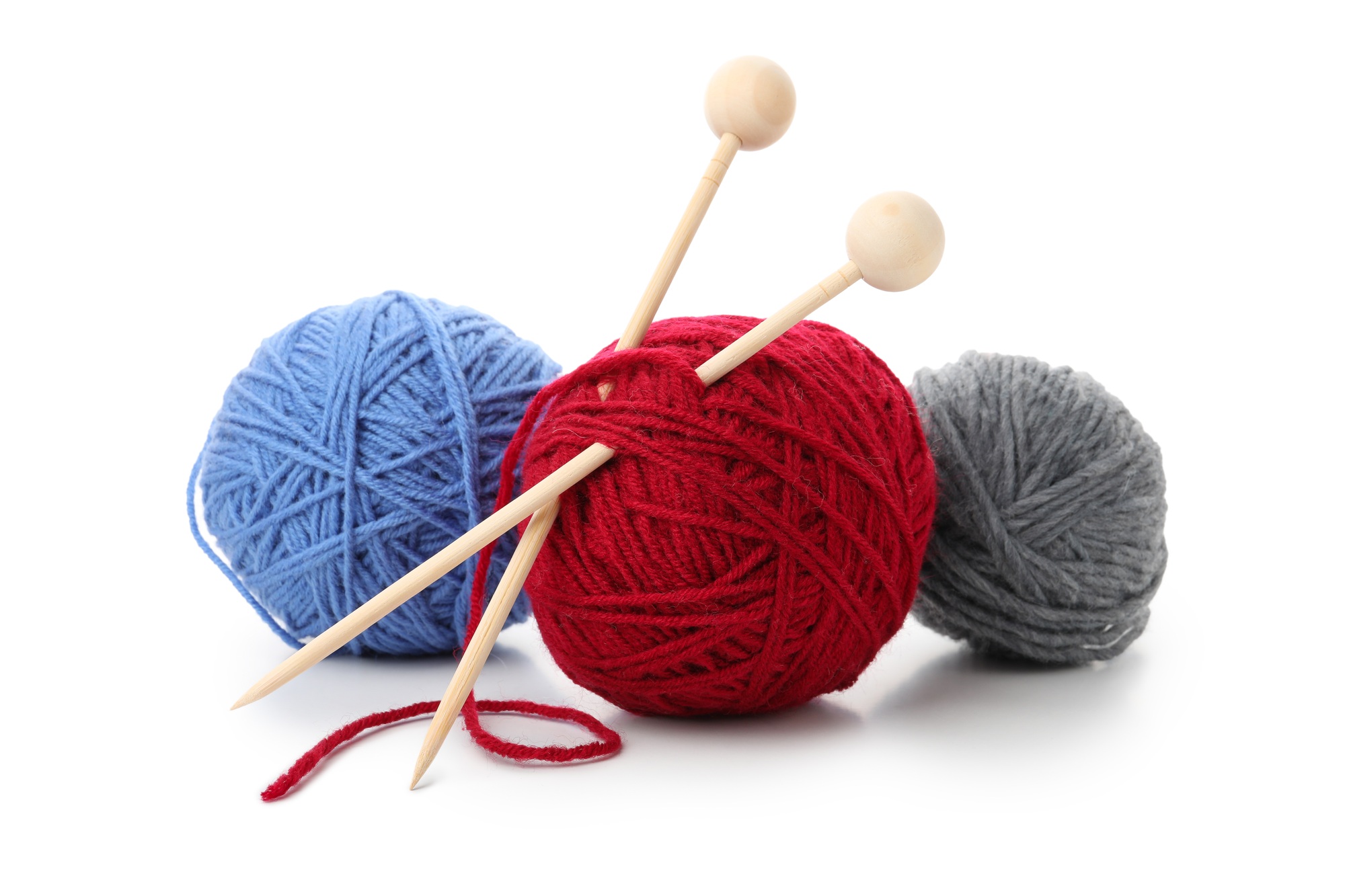 Multi colored balls of yarn with knitting needles, isolated on white background